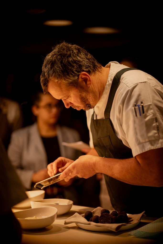 Chef Thomas puts the finishing touches on a plate of food