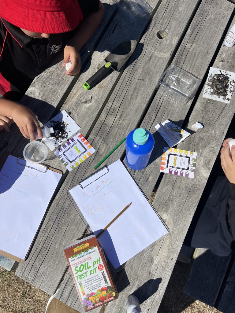 A soil testing kit is shown laid out on a table